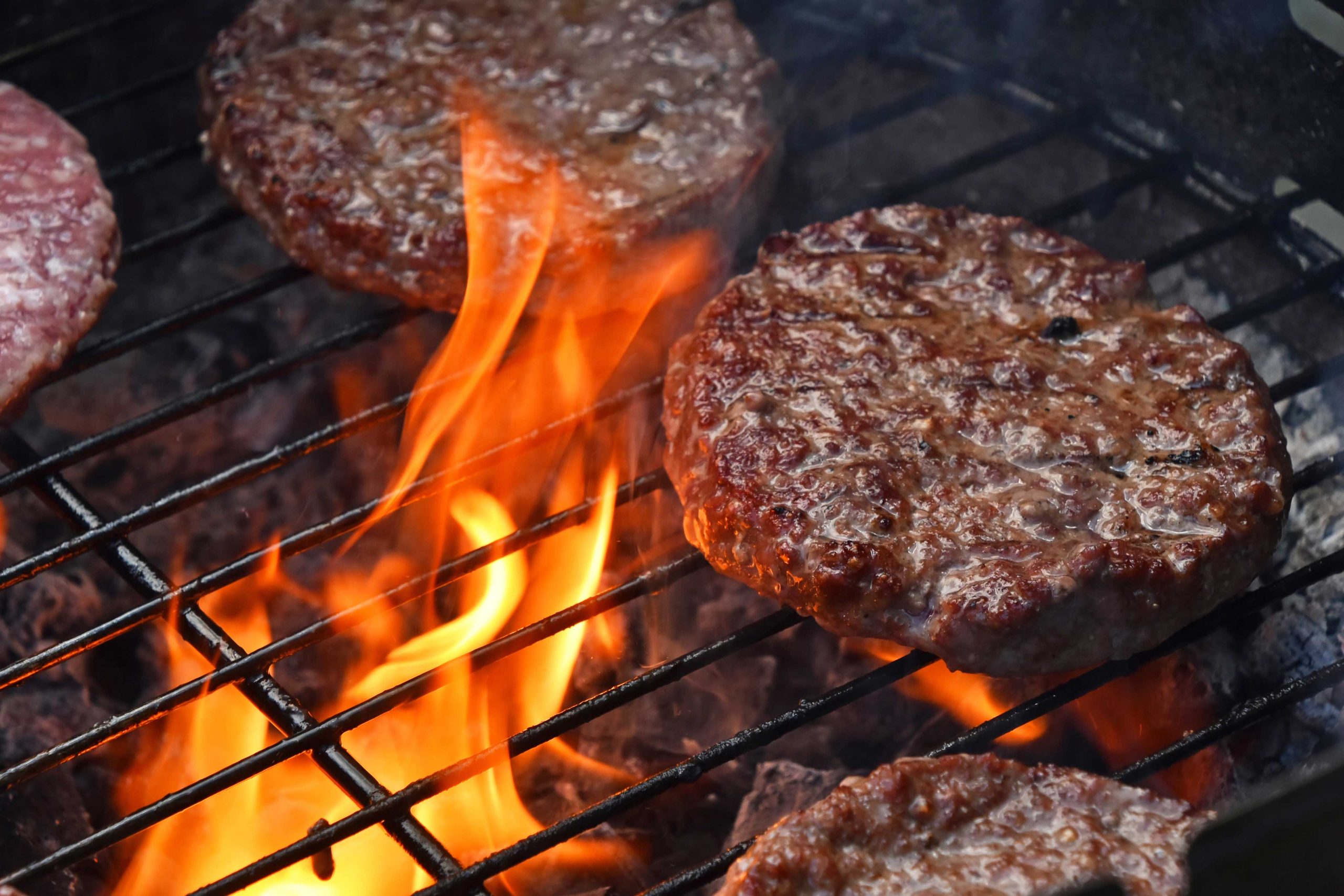 Beef or pork meat barbecue burgers for hamburger prepared grilled on bbq fire flame grill